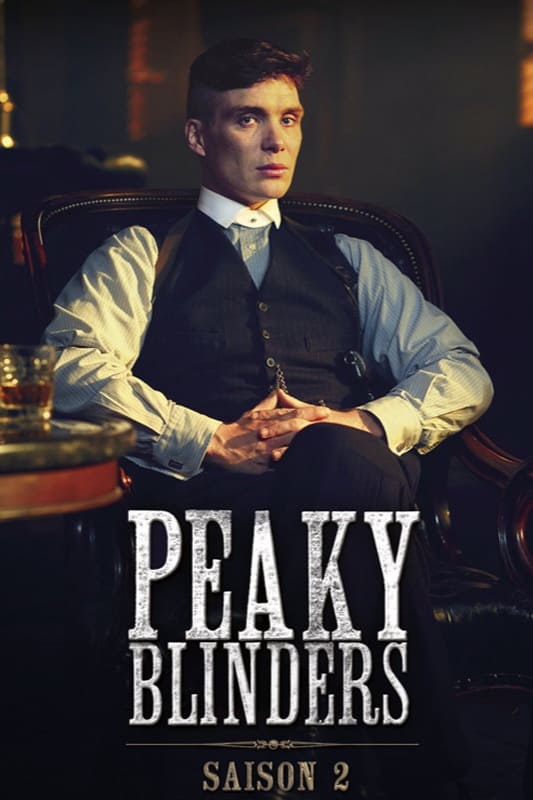 A man in a suit sits in a leather chair with his hands folded, looking serious. The text Peaky Blinders Saison 2 is displayed prominently at the bottom, hinting at its availability on Malta IPTV.
