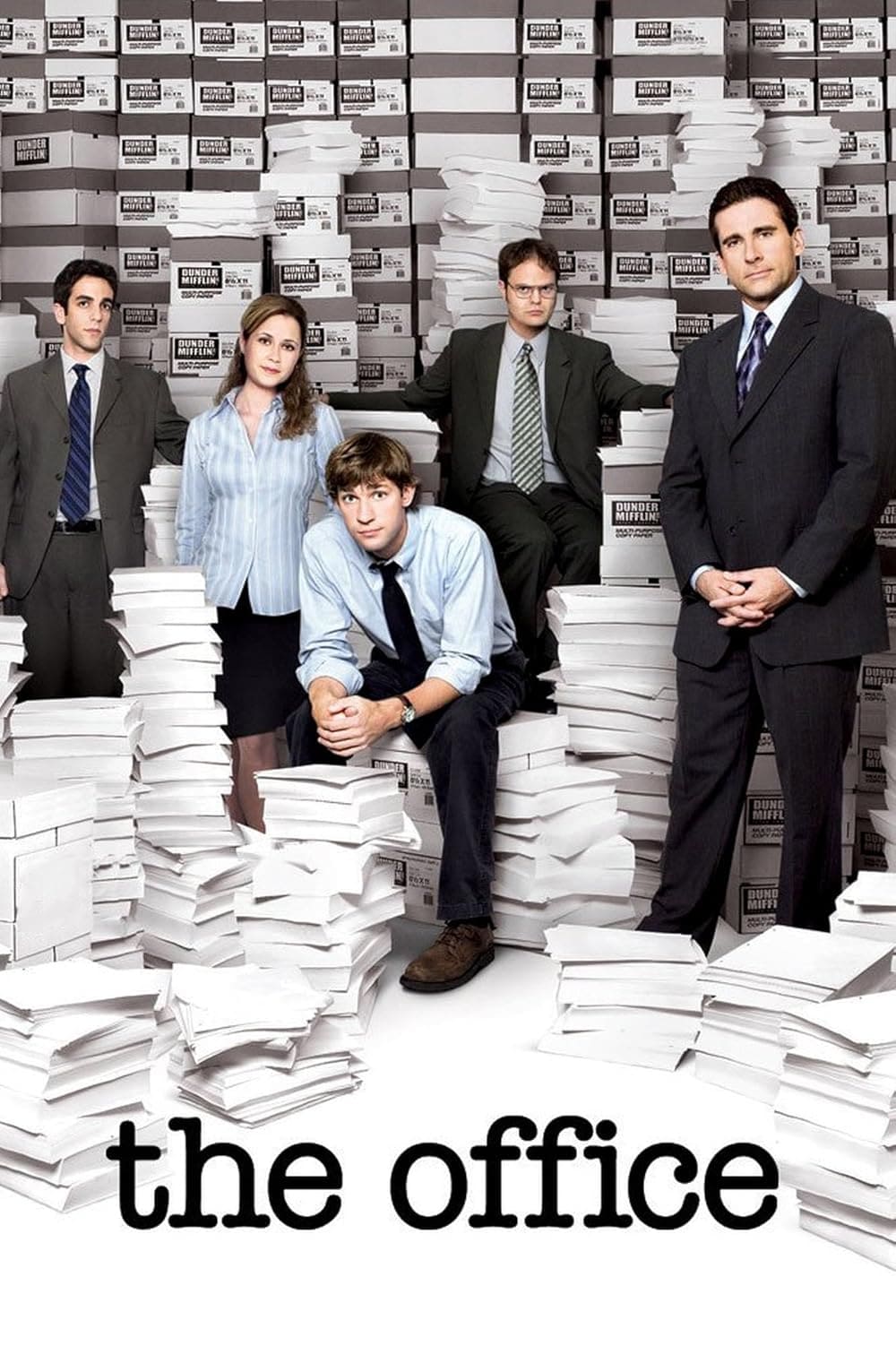 Five office workers stand or sit among tall stacks of paper in front of shelves packed with boxes. The show's title, the office, appears at the bottom of the image in lowercase black letters, as seen on Malta IPTV.