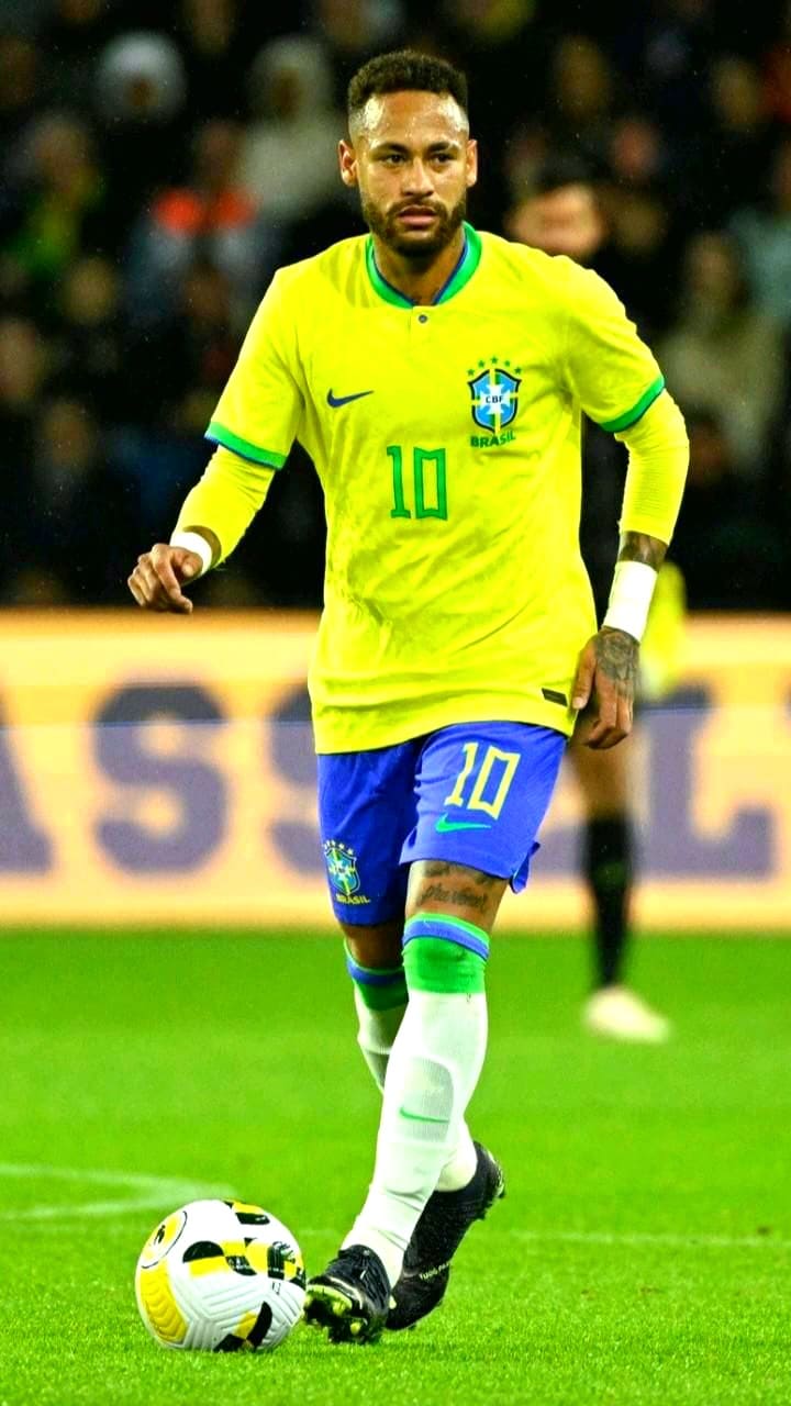 A soccer player in a yellow Brazil jersey with number 10 is dribbling a ball on the field during a match, as fans watch from the stands—a scene you can catch live with Malta IPTV.